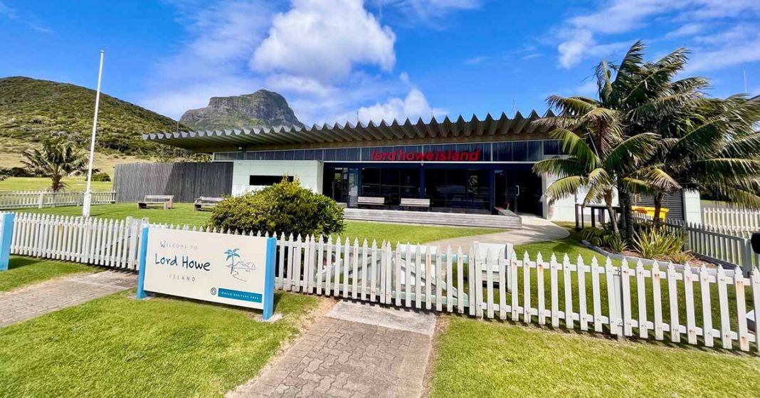 Lord-Howe-Island-Welcome-to-Airport A beautiful image of sunny blue sky over the Lord Howe Island Airport. A welcome sign in the foreground welcomes you to Lord Howe Island.